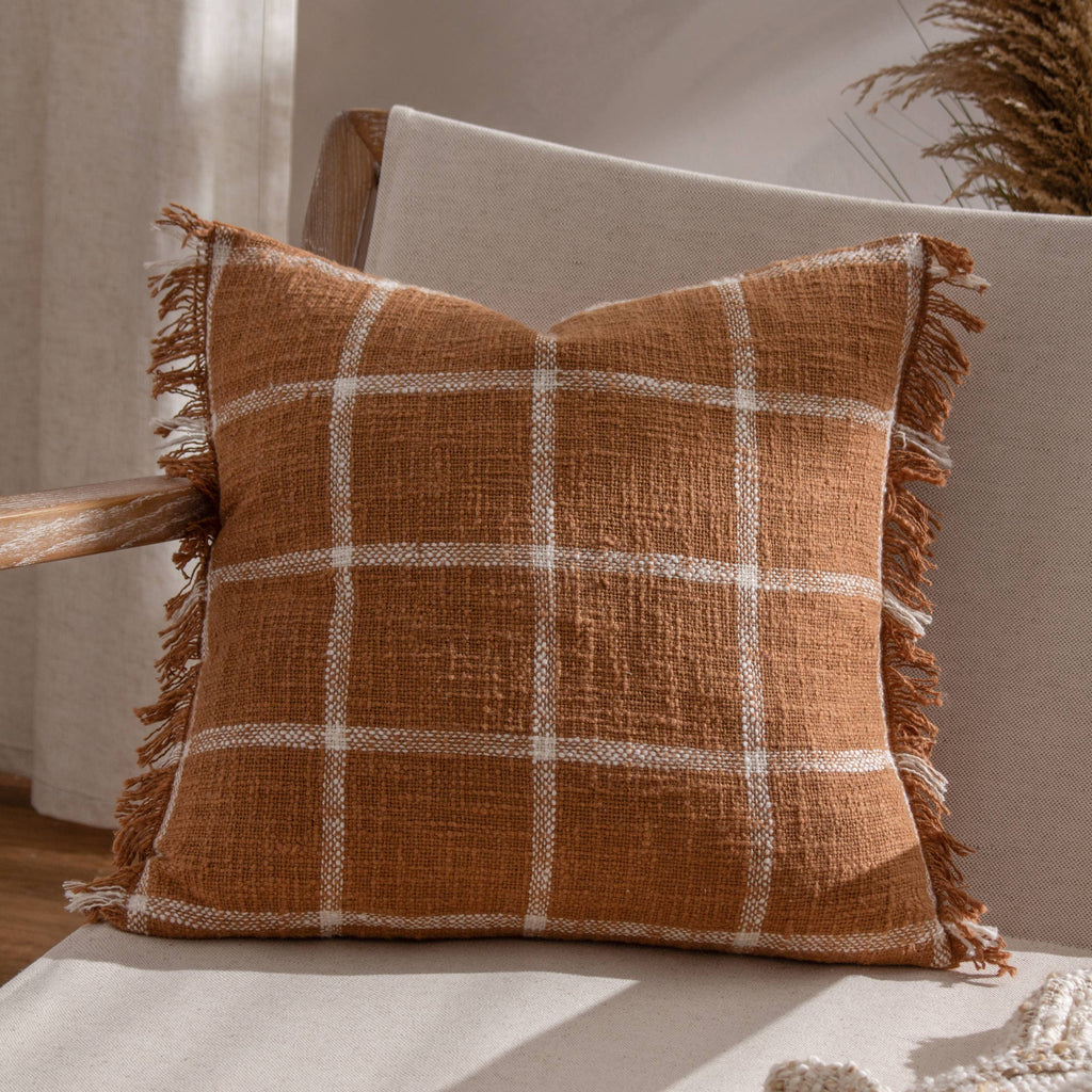 tasselled orange check cushion