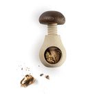 Wooden nutcracker with cracked walnuts on a white background