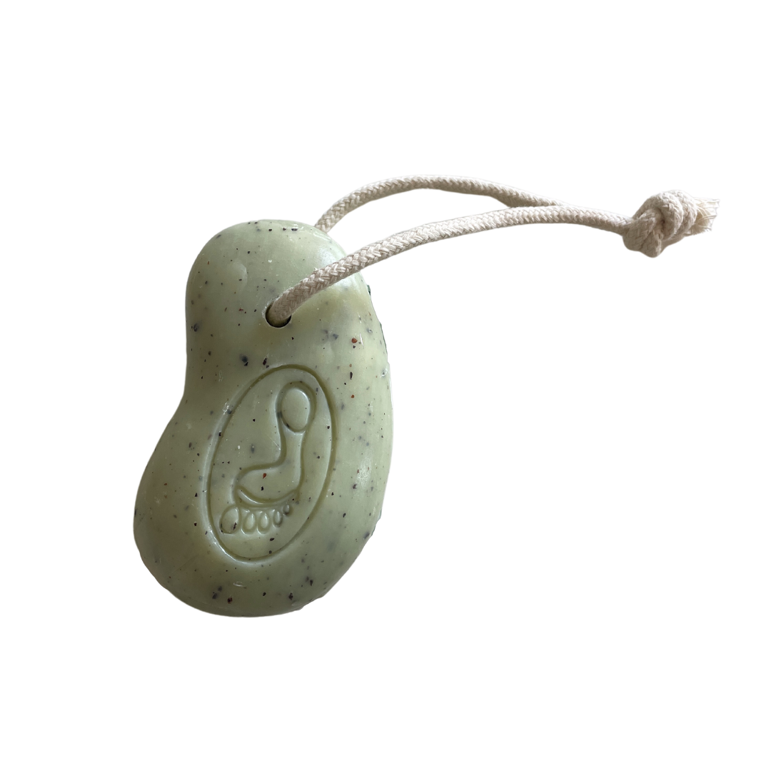 Green soap on a rope on a white background