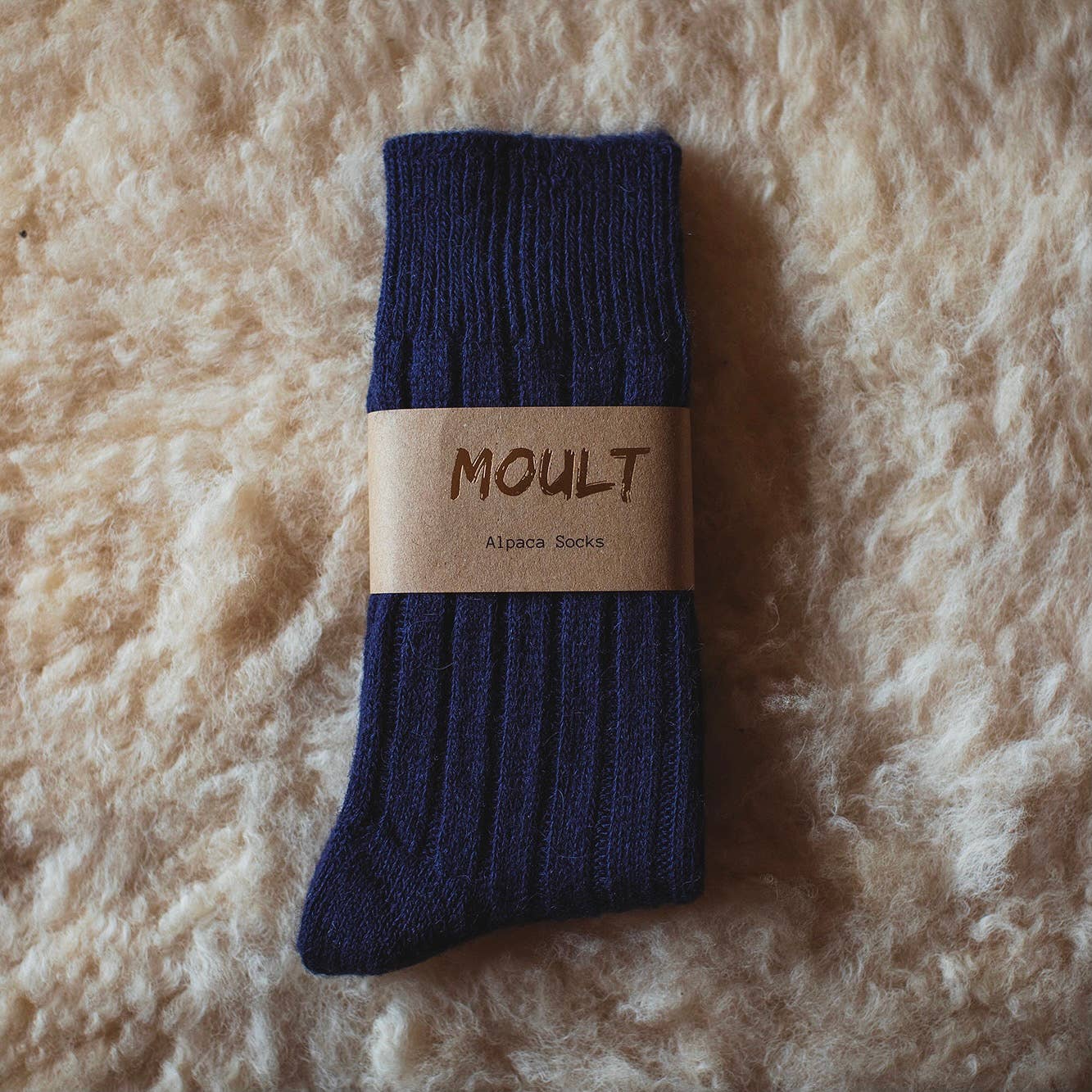 British Made Navy Alpaca Socks on a sheepswook background