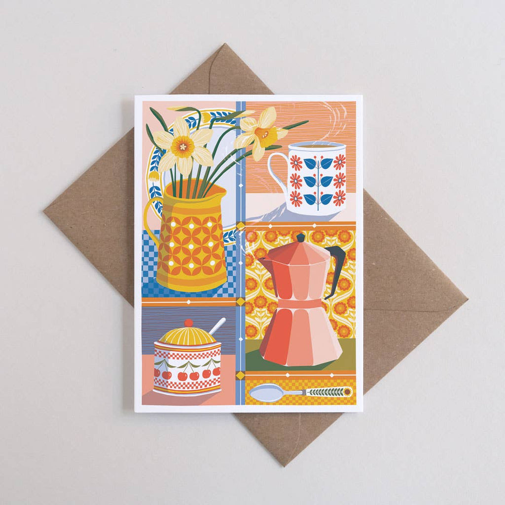 Greeting card with kitchen-themed design featuring a pitcher, cup, and flowers on a brown envelope.