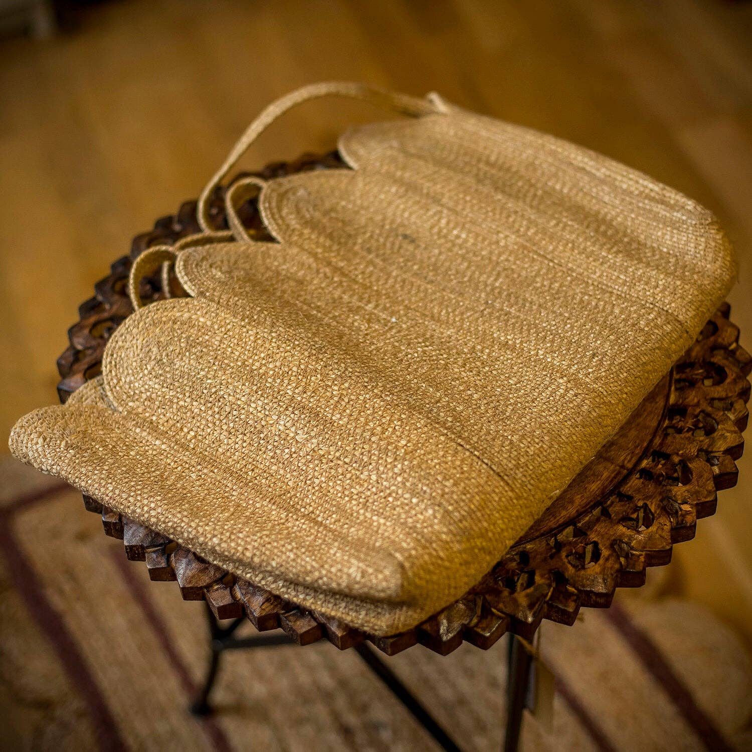 Straw bag on a wooden stool with a blurred background