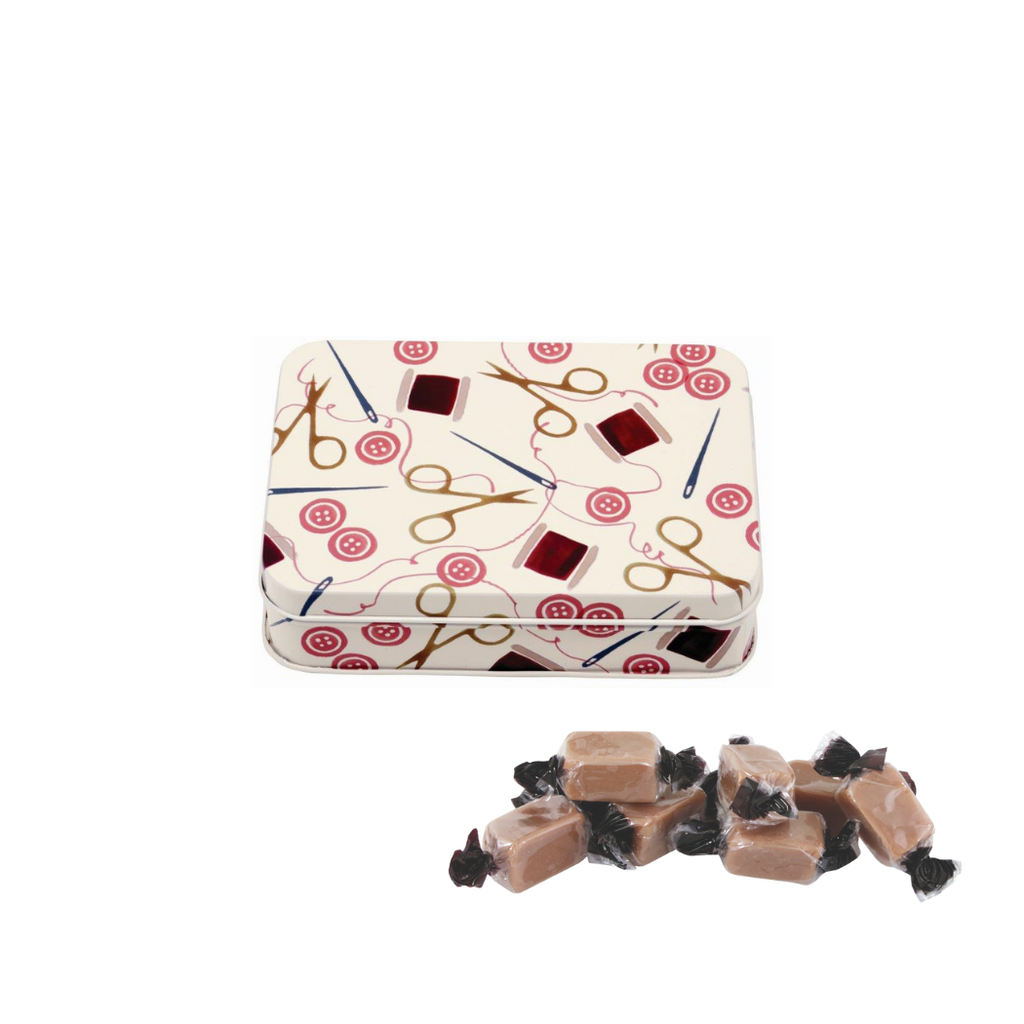 Small rectangular tin with sewing-themed design on a white background and individually wrapped fudge.