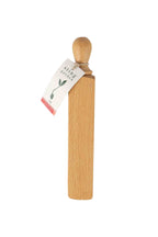 Wooden door wedge with a label on a white background