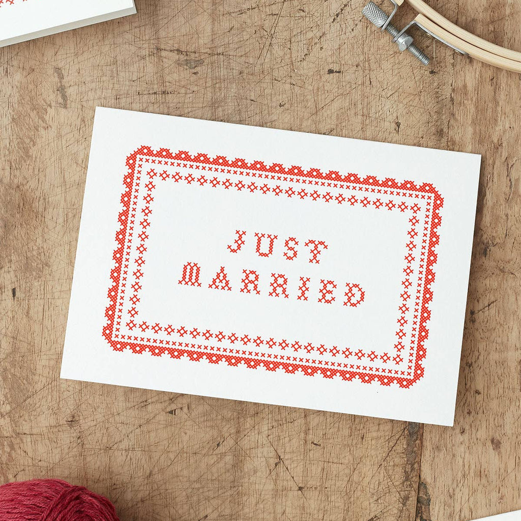 Just Married Wedding Card  with red  Cross Stitch design on a wooden background