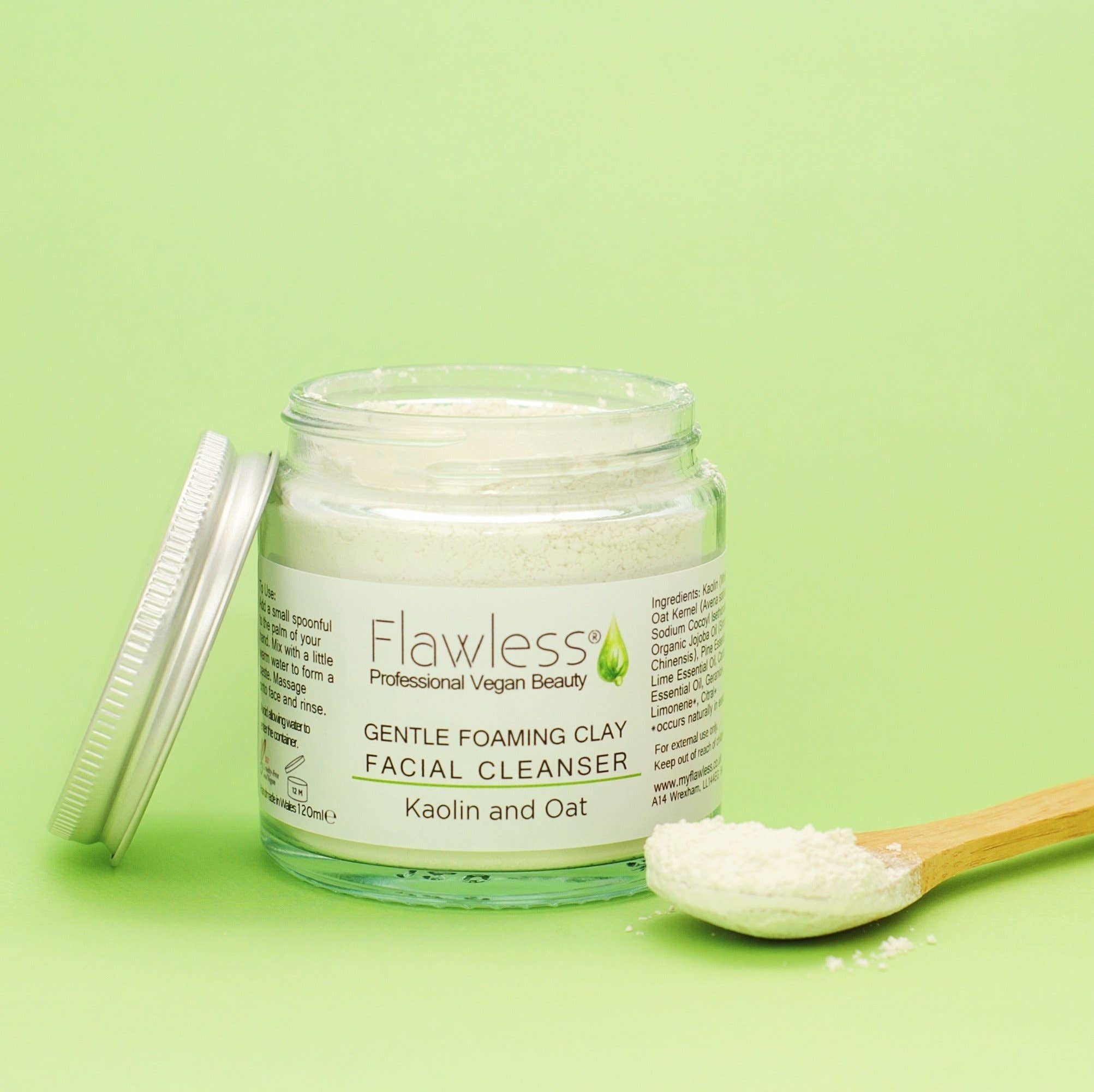 Jar of Flawless Gentle Foaming Clay Facial Cleanser on a green background