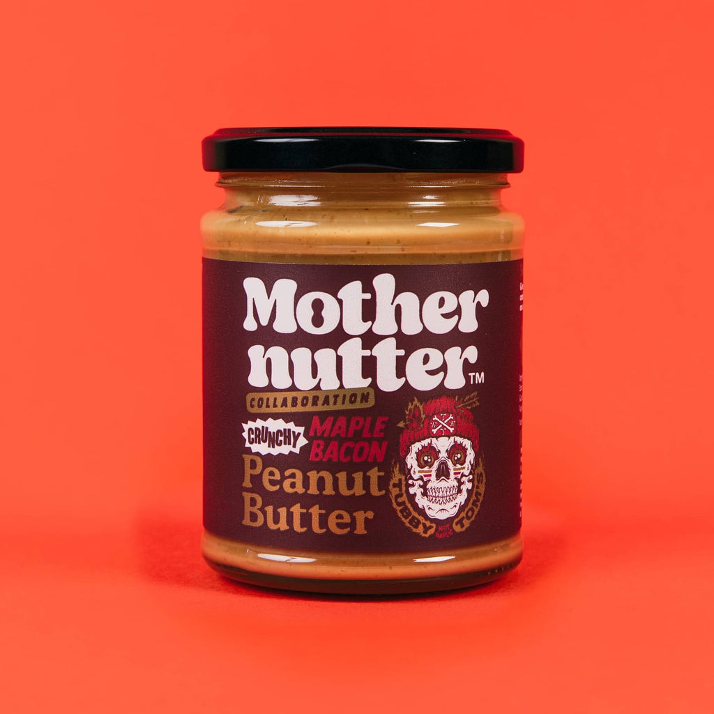 A jar of Mothernutter Crunchy Maple Bacon Peanut Butter on a warm orange background  - All Good Things
