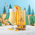 Striped bag of Pina Colada Gummies on a yellow background, styled with a cocktail glass - All Good Things