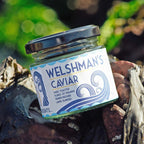 A jar of Welshman's Caviar Seaweed Condiment on the beach